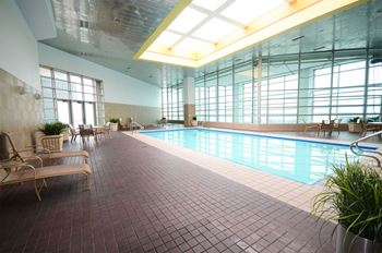 a swimming pool in a large building with windows